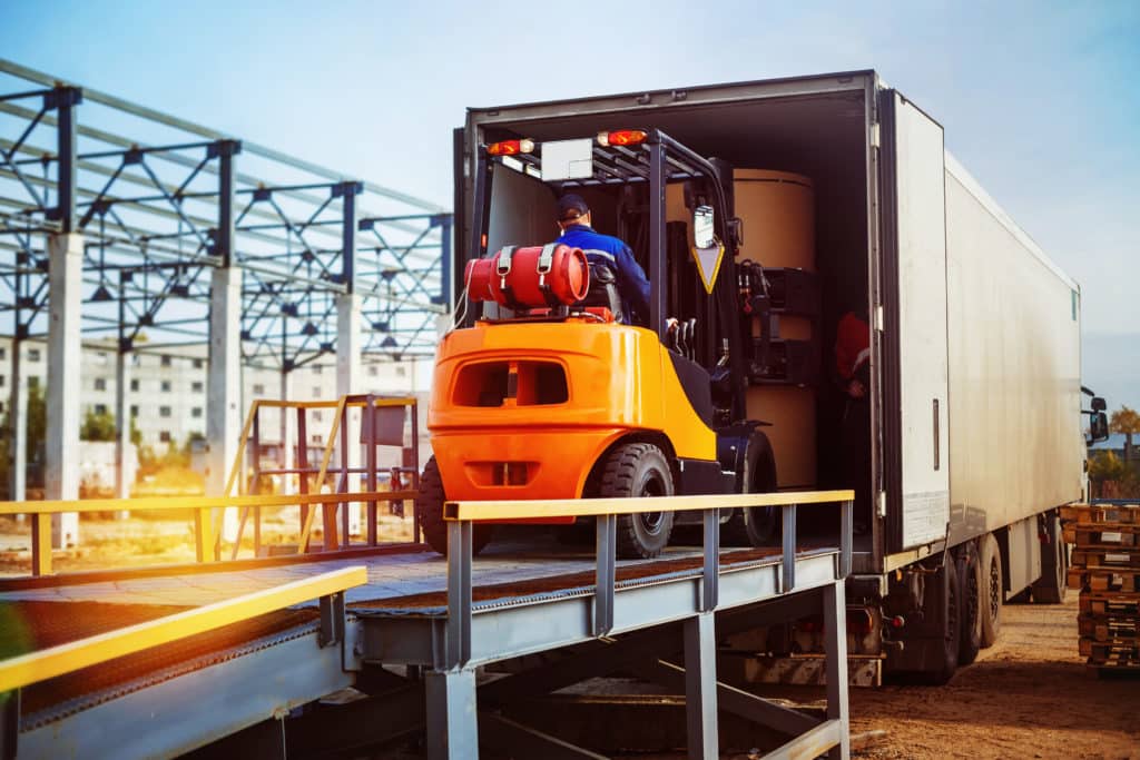 Cargo being loaded onto a truck using a forklift for LTL shipping.