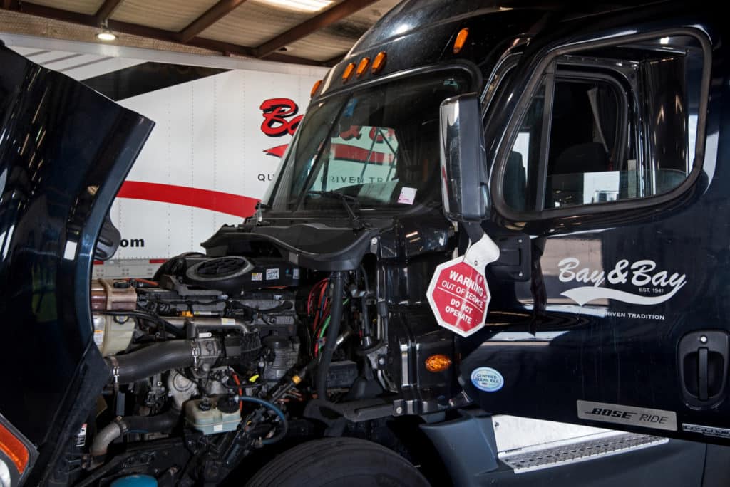 Diesel engine on black semi with Bay & Bay logo