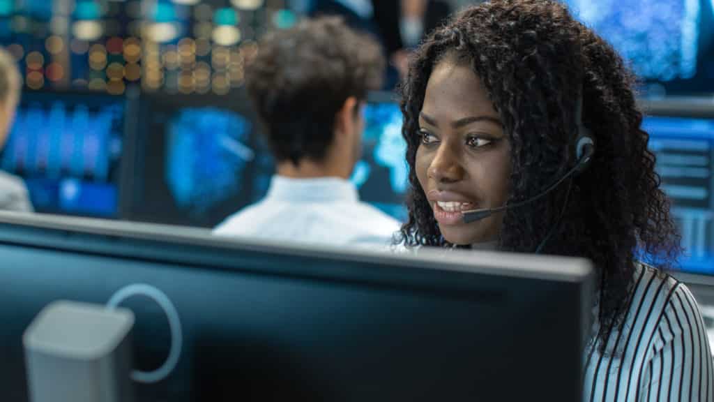 Female customer service/logistics employee working at a computer