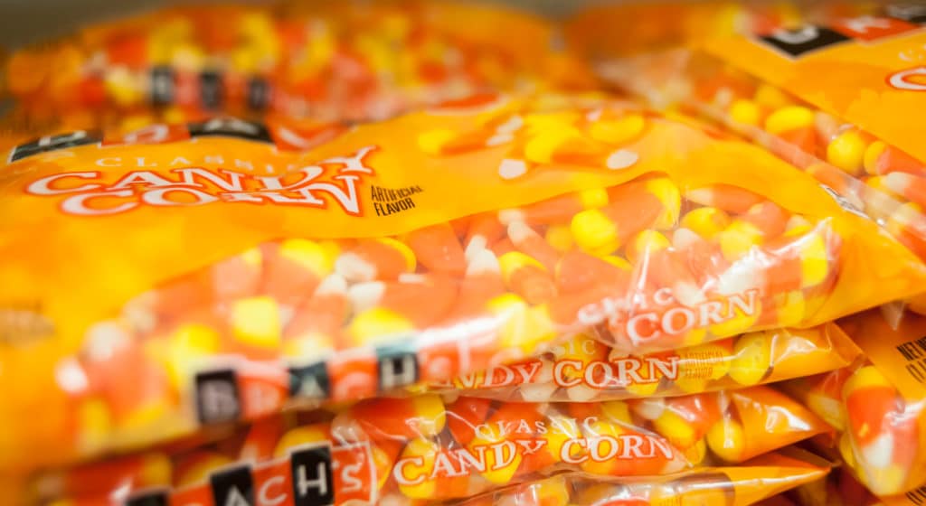 Candy corn bags laying on the shelves of a store on time from logistics companies for Halloween.