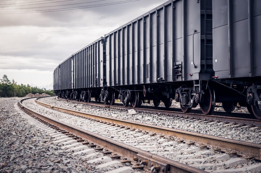 A photo of intermodal transportation by rail with 40-foot shipping containers on the cargo.