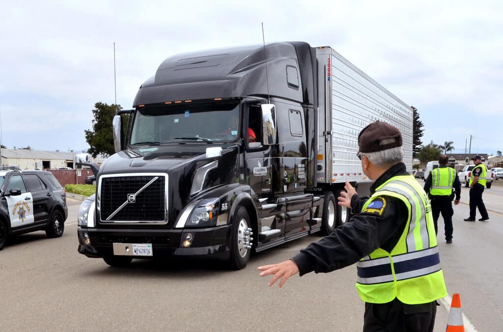 A photo of a truck inspection during safe driver week to ensure all commercial and passenger drivers and driving safely.