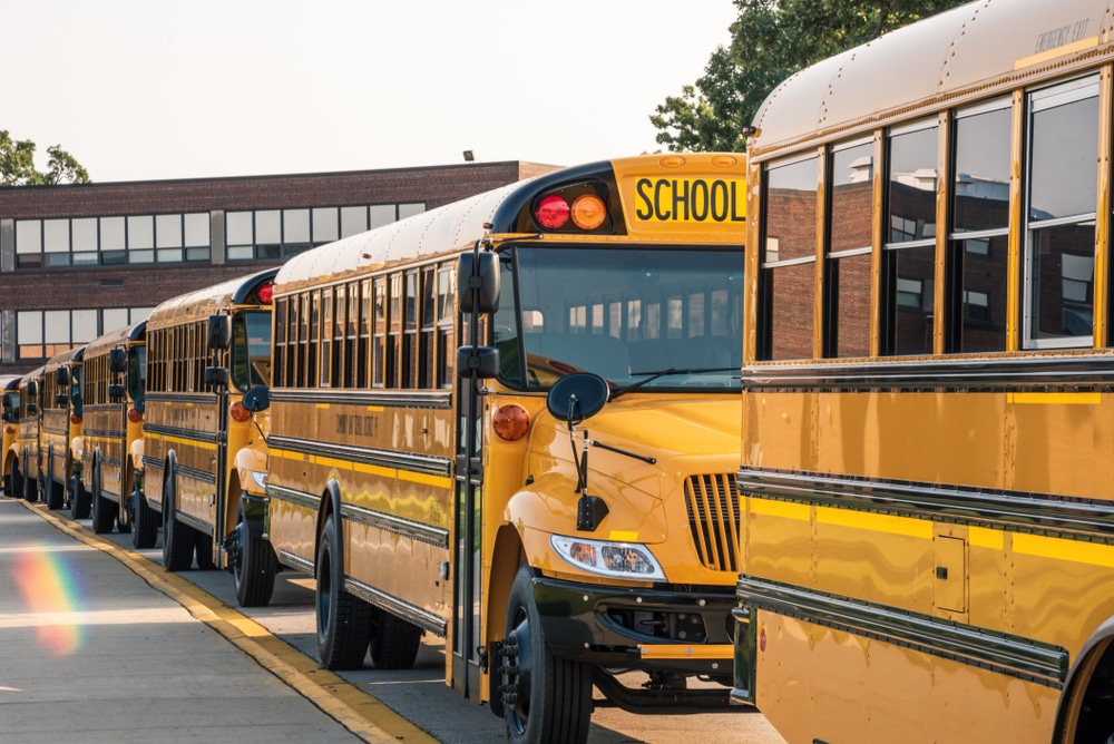 A photo of yellow school buses lined up getting ready for back-to-school season.
