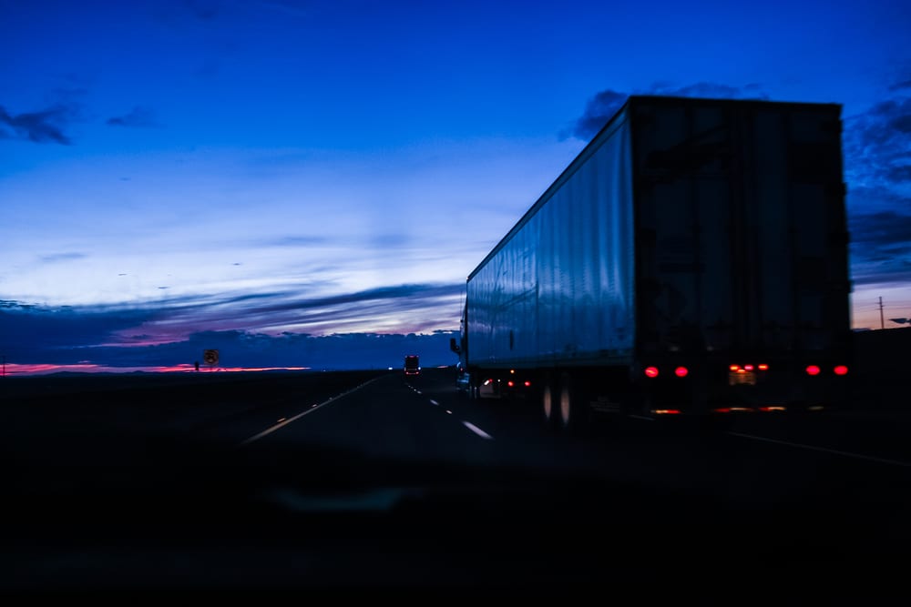 A Bay & Bay truck driving at dusk after daylight savings time. This driver is following Bay & Bay's daylight savings tips for truckers to stay safe on the road during daylight savings time.